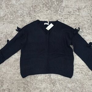 OFF-THE-SHOULDER BOW APPLIQUE SWEATER